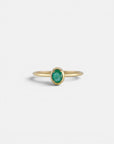 Yellow gold ring with oval emerald and rounded bezel