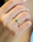 Yellow gold ring with oval emerald and two white diamonds