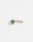 Yellow gold ring with oval emerald and decorated bezel