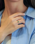 Yellow gold ring with oval emerald and decorated bezel