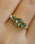 Ring with oval green sapphires and lateral white diamonds