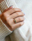Ring with oval green sapphires and lateral white diamonds