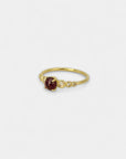 Yellow gold ring with cabochon garnet and white diamonds in scale