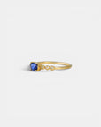 Yellow gold ring with blue sapphire and round elements with white diamonds