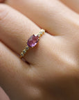 Yellow gold ring with pink sapphire and round elements with white diamonds