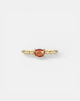 Yellow gold ring with orange sapphire and round elements with white diamonds