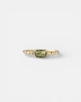 Yellow gold ring with green sapphire and round elements with white diamonds