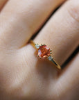 Yellow gold ring with orange heart-shaped synthetic corundum and two white diamonds