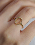 Yellow gold ring with oval profile of white diamonds