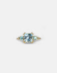Yellow gold ring with square light blue topaz and side topaz and aquamarine