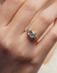 Yellow gold ring with square light blue topaz and side topaz and aquamarine