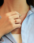 Yellow gold ring with burnt orange sapphire and white diamonds