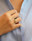 Yellow gold ring with tilted teal tourmalines and white diamonds