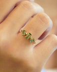 Yellow gold ring with tilted teal tourmalines and white diamonds