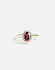 Yellow gold ring with oval rhodolite and white diamond contour