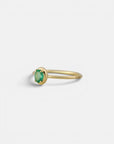 Yellow gold ring with oval emerald and rounded bezel