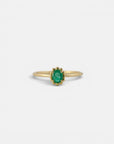 Yellow gold ring with oval emerald and decorated bezel