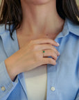 Yellow gold ring with oval emerald and decorated bezel
