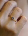 Ring with light blue sapphire and white diamonds