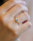Ring with central light blue sapphire and white diamonds