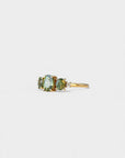 Ring with oval green sapphires and lateral white diamonds