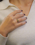 Ring with oval green sapphires and lateral white diamonds