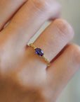 Yellow gold ring with blue sapphire and round elements with white diamonds