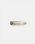 Yellow gold ring with blue sapphire and round elements with white diamonds