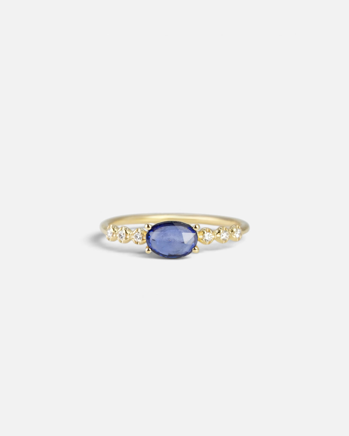 Yellow gold ring with blue sapphire and round elements with white diamonds