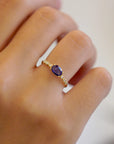 Yellow gold ring with blue sapphire and round elements with white diamonds
