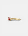 Yellow gold ring with orange sapphire and round elements with white diamonds