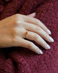 Yellow gold ring with orange sapphire and round elements with white diamonds