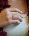Yellow gold ring with ruby and round elements with white diamonds