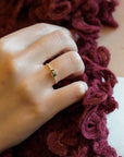 Yellow gold ring with green sapphire and round elements with white diamonds