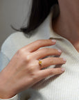 Yellow gold ring with heart-shaped yellow synthetic corundum and two white diamonds