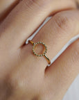 Yellow gold ring with round profile of white diamonds