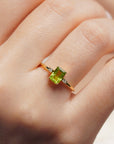 Yellow gold ring with rectangular peridot and white diamonds