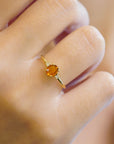 Yellow gold ring with burnt orange sapphire ​​and white diamonds