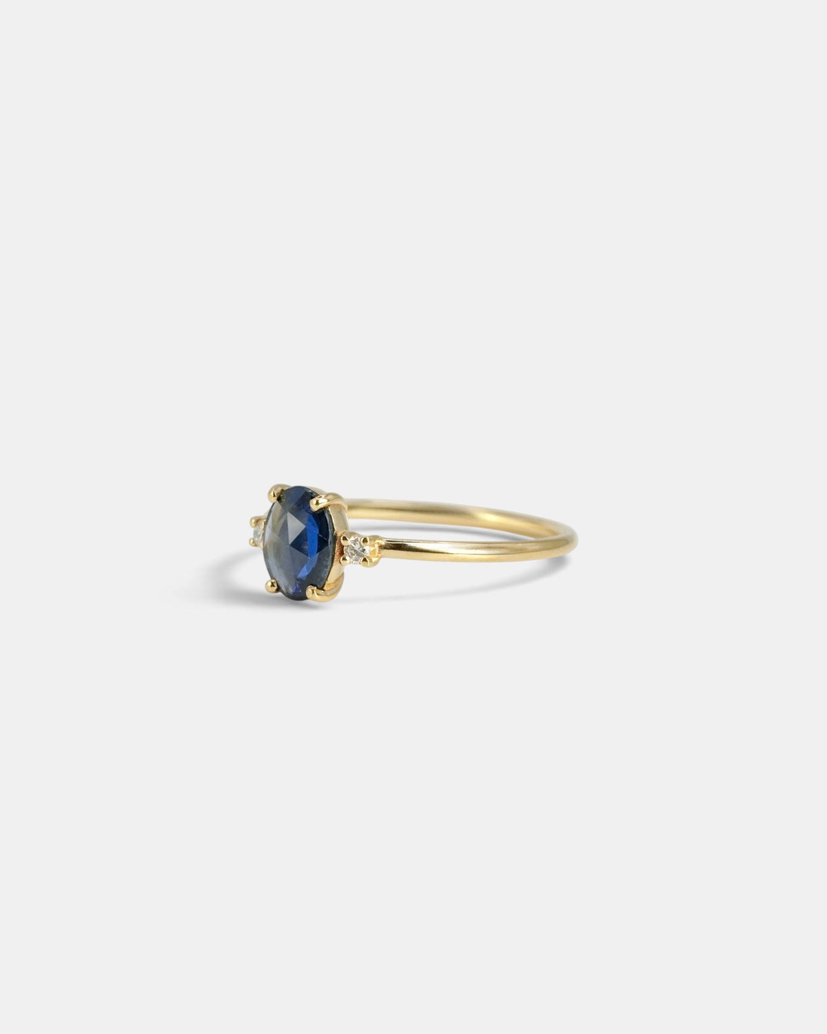 Yellow gold ring with oval rose-cut blue sapphire and white diamonds