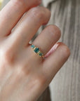 Yellow gold ring with teal tourmalines and white diamonds