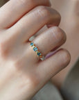 Yellow gold ring with square teal tourmalines and white diamonds