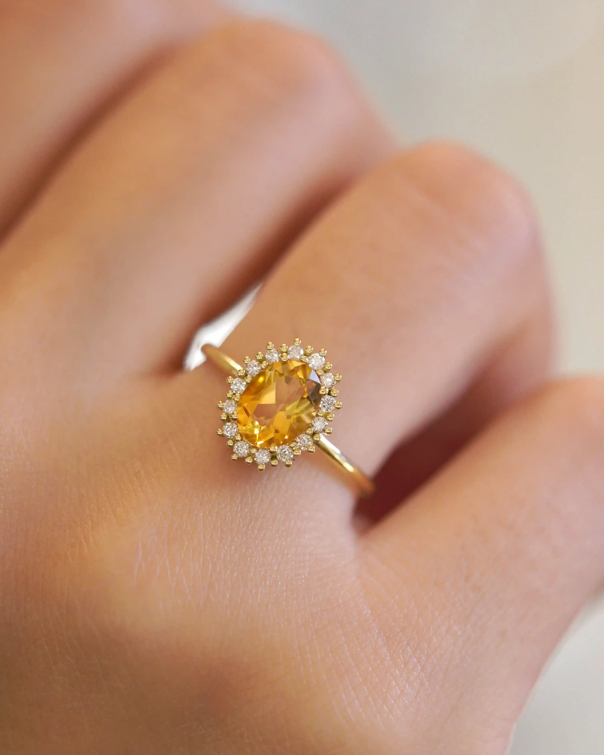 Yellow gold ring with oval citrine and white diamond contour