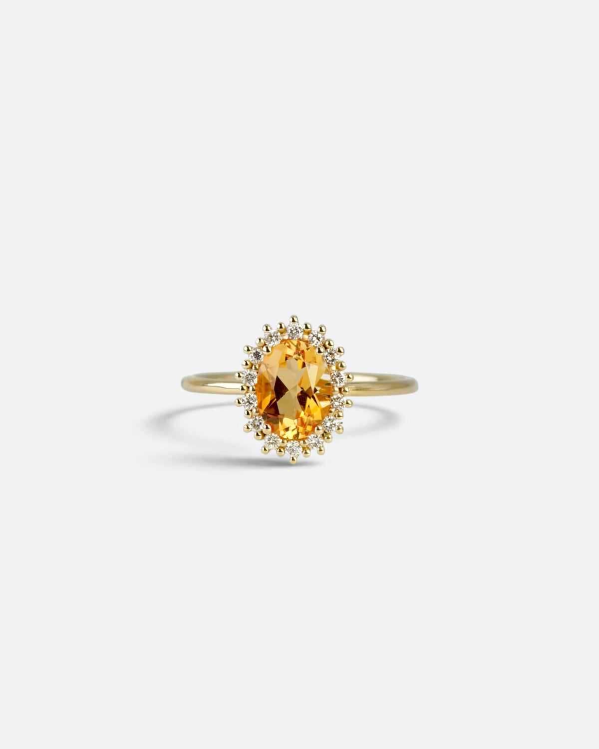 Yellow gold ring with oval citrine and white diamond contour