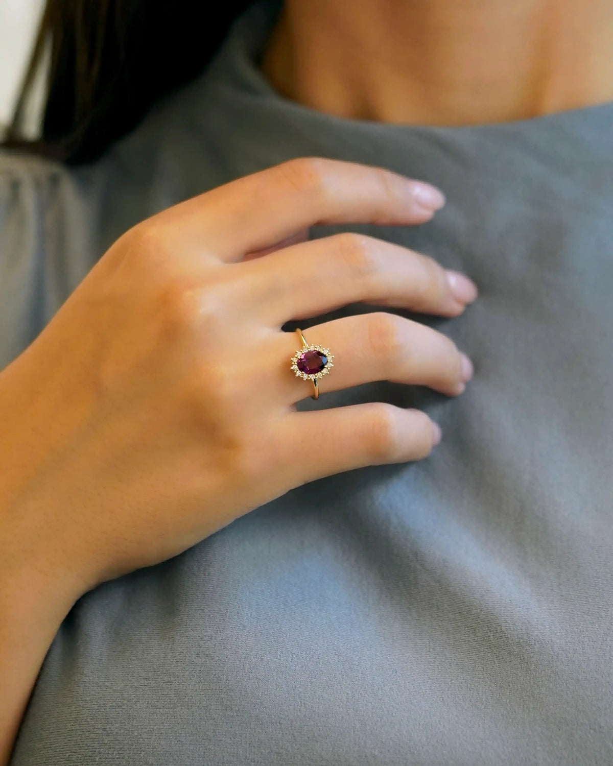 Yellow gold ring with oval rhodolite and white diamond contour