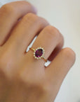 Yellow gold ring with oval rhodolite and white diamond contour