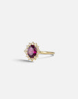Yellow gold ring with oval rhodolite and white diamond contour