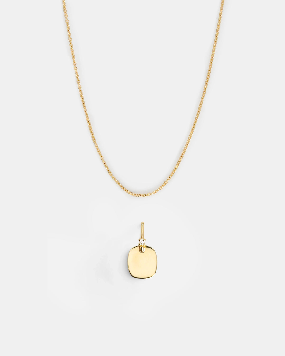 Rectangular gold pendant with white diamond detail