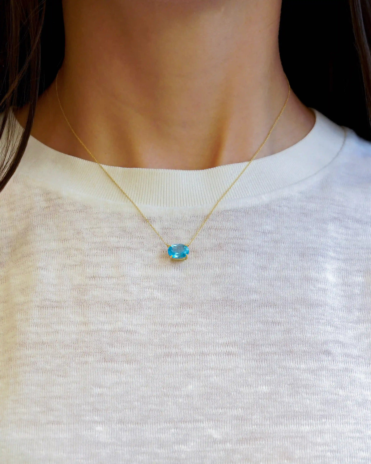 Yellow gold necklace with oval light blue topaz