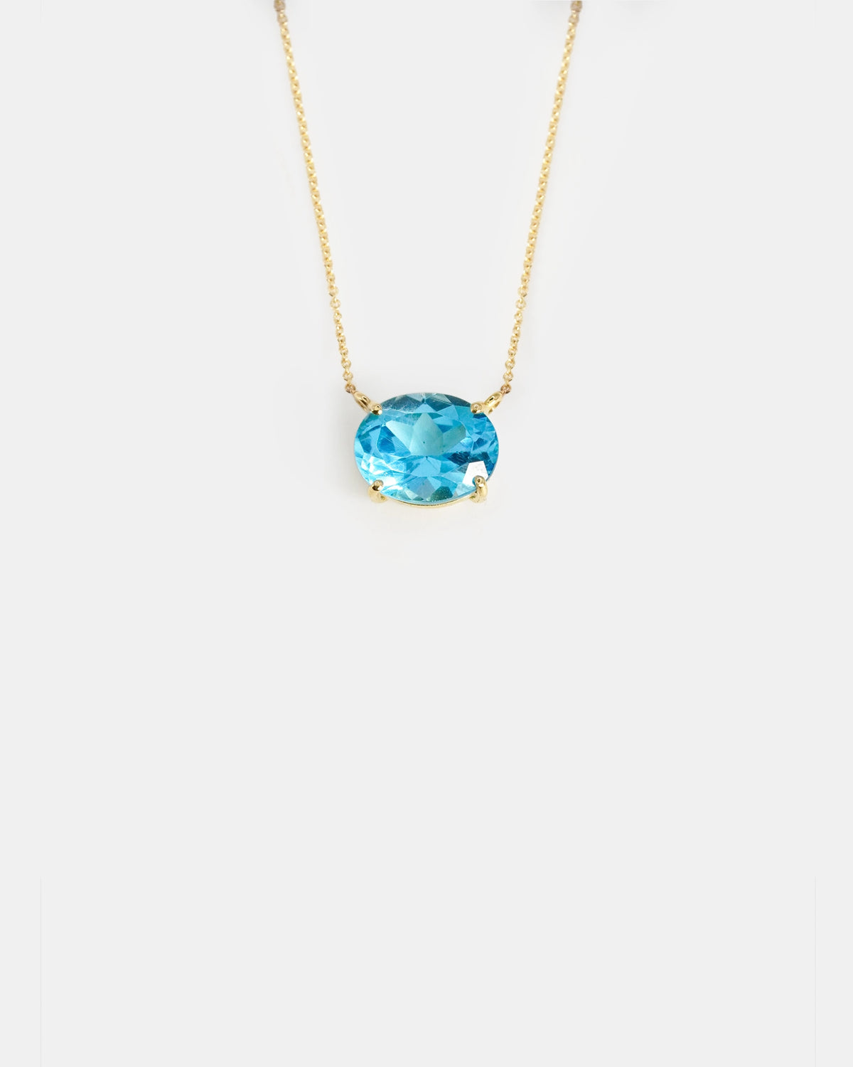 Yellow gold necklace with oval light blue topaz