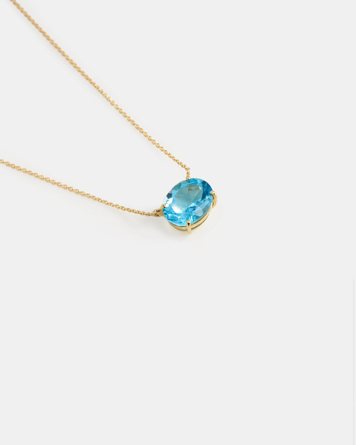 Yellow gold necklace with oval light blue topaz